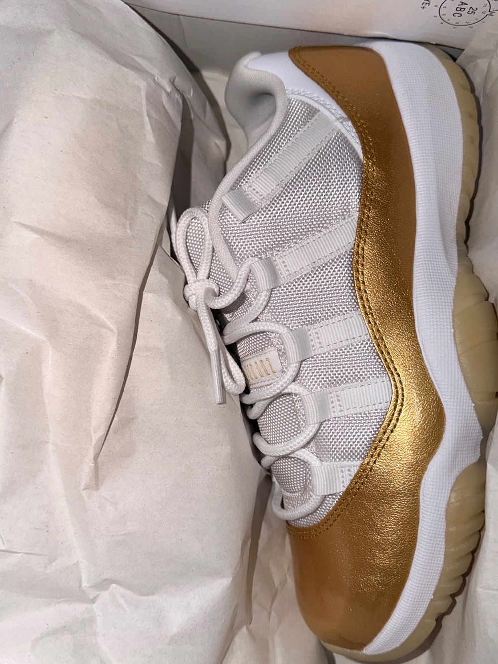 Jordan Women’s White and Metallic Gold Low-Top Sneakers